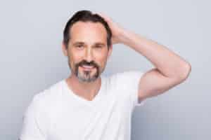 aged man looking mirror hands checking hairstyle